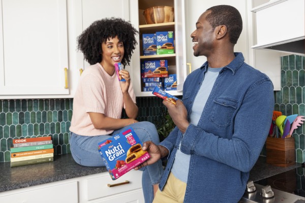 a mom and dad enjoying a Nutri-Grain bar as an afternoon snack
